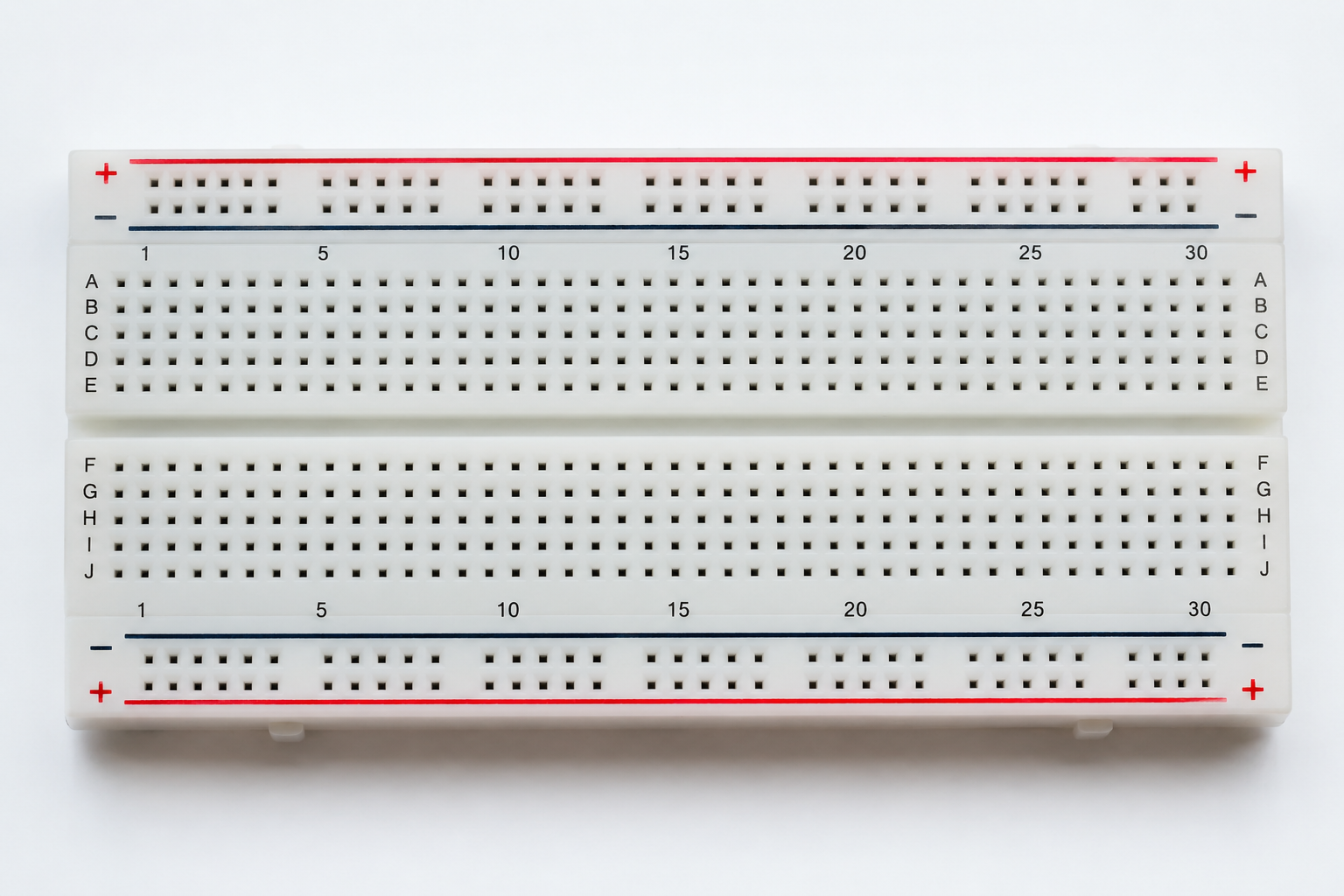 Solderless breadboard with numbered columns, A to J terminal rows, red positive power rails, blue negative power rails and centre trench